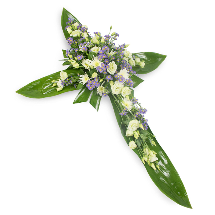 This heartfelt cross is composed to read as both a symbol of faith and a gentle embrace, set against a stark white field so every texture and hue can be seen clearly. The backbone of the design is an architectural placement of large, glossy Ti leaves; their deep emerald tones and distinct veins form crisp arms and a central point, suggestive of shelter and permanence. Concentrated at the crossing and echoing along the arms are clusters of soft white and creamy lisianthus, their layered petals unfurling like quiet prayers, paired with small white chrysanthemums that bring a compact, luminous punctuation to the surface. Interwoven among these are sprays of tiny lavender or pale purple limonium/asters, lending a silvery, ethereal shimmer and a cool tonal counterpoint that deepens the arrangement without diminishing its tranquility. Finely textured green fillers peek through the blooms, adding air and a natural, meadow-like softness against the leaf base. The lighting is gentle and even, revealing petal translucence and the waxy sheen of the leaves while maintaining a restrained, reverent mood. Intended for use at funerals, memorials or church services around Hatch End-from quiet services near Pinner Memorial Park to small chapel gatherings-this cross offers a composed expression of sympathy and remembrance crafted with experienced hands and an understanding of the local community's need for dignity and comfort.