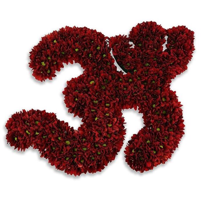 A substantial, plush numeral '33' meticulously formed from hundreds of small, button-style chrysanthemums in a deep burgundy or crimson tone. The two digits are composed of densely massed, multi-petaled blooms whose petals overlap to create a luxurious, velvety surface; scattered among the red heads, tiny green centres and the occasional small leaf provide soft, organic punctuation that lifts the colour and adds texture. The composition sits against a pristine white field, the contrast sharpening each curve and terminal so the number reads with firm presence, while a gentle, diffuse gray shadow beneath gives the whole piece a sensation of being slightly raised, like a commemorative plaque of blossoms. The tactile quality is unmistakable - compact, almost cushion-like where the flowers meet, yet precise in its outline - suggesting both celebration and gravitas. This floral number could mark a 33rd birthday, a poignant anniversary, a team jersey or a memorial tribute; the richness of the reds lends an air of warmth and dignity that suits any of these contexts. Picture it prepared with local attention to detail, the kind of piece a Hatch End florist would hand-deliver for a milestone occasion in the neighbourhood, whether to a family on Hatch End High Street or for display at a community event near Pinner Park. The overall tone combines refined craftsmanship, tactile beauty, and a quietly festive spirit.