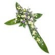 A solemn, elegant floral cross photographed against a plain white background and viewed from a slight overhead angle, the image emphasising clean lines and a tranquil silhouette. The cross is constructed from broad, glossy tropical Ti leaves whose rich green surfaces and visible veins form a lush, protective frame for the floral work; the leaves are laid with care to define the horizontal and vertical arms and to create a strong, natural foundation. At the intersection and running gently along each arm sits a dense spray of soft, creamy-white lisianthus with their ruffled, multi-layered petals, accompanied by clusters of small, pure white daisy-like chrysanthemums that add bright, rounded texture. Interspersed throughout are delicate, star-shaped lavender or pale purple limonium or aster sprays, introducing a whisper of cool colour that deepens the composition without disturbing its serenity. Finer green filler foliage is woven through the blooms, lending lightness and a subtle contrast to the waxy leaf base. The lighting is soft and even, washing the arrangement in a calm, spiritual glow that highlights petal translucence and the smooth sheen of the leaves. The scent suggested is faintly green and floral-reserved and comforting rather than overpowering-suitable for a funeral service, memorial or church ceremony. This arrangement reads as a dignified expression of remembrance, its classic colour palette and symbolic cross shape offering a visual message of peace, faith and thoughtful consolation for mourners in Hatch End and nearby communities.